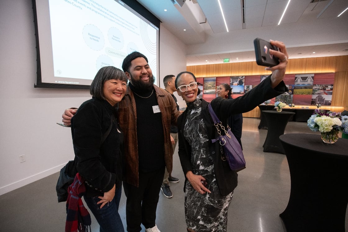 Three community members taking a photo together in the CZI Community Space