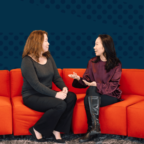Monica Milligan, executive director of Gradient Learning, and Sandra Liu Huang, CZI’s head of education, sit on a red couch in conversation.
