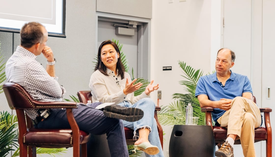 Image of Michael Fischbach, Priscilla Chan, and Steve Quake on stage, speaking together.