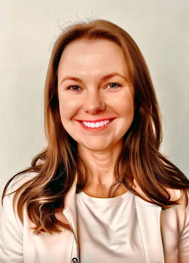 A professional headshot of a smiling woman with medium-length brown hair styled in soft waves. She is wearing a white blouse and a light-colored blazer. The background is a soft, neutral color, and she has a bright and approachable expression, looking directly at the camera.